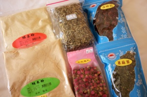 Clockwise from top left: mung bean powder, mugwort, roselle, stinging nettle, rose, brown rice powder